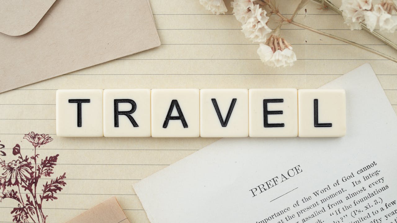 brand-03 Travel-themed flat lay with Scrabble tiles, dried flowers, and stationery creating a vintage vibe.